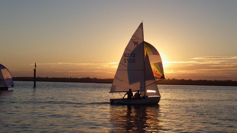 The sun sets during Lymington Town SC Wednesday evening racing photo copyright Alastair Beeton taken at Lymington Town Sailing Club and featuring the Wayfarer class