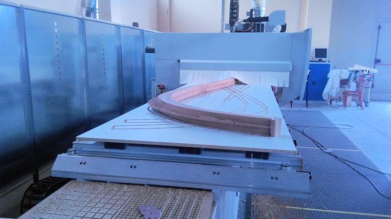 The CNC machine has introduced a camber into both sides at the stem so the planks will butt up against a flat surface when they are fitted. - photo © WSI