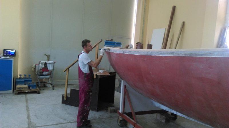 A craftsman applies epoxy to the exposed grain of the deck plywood to ensure it is fully sealed - photo © Wessex Resins & Adhesives