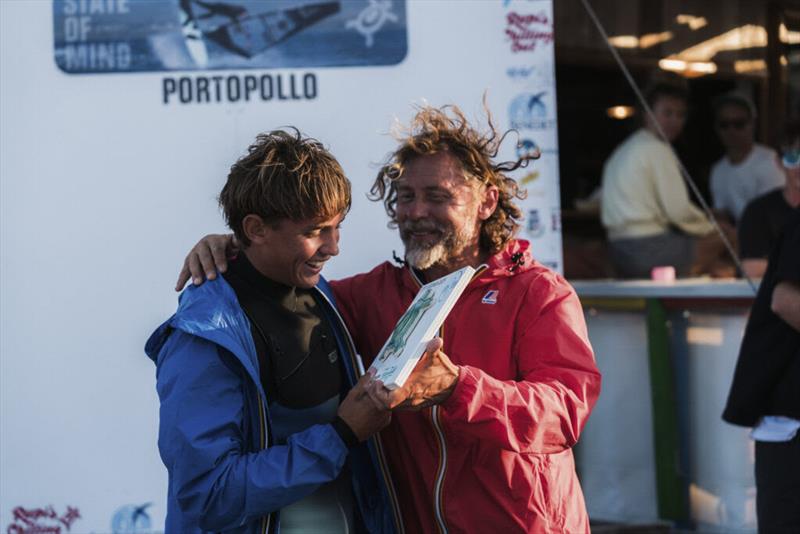 Ercole Rosso-Chioso shared a wholesome moment of joy with his father and main event organizer Augusto before stepping up onto the podium photo copyright Richard Buchner taken at  and featuring the Windsurfing class