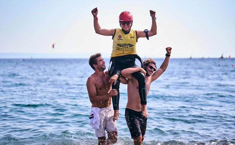 Champion Vaina Picot (FRA) is rasied aloft by team-mates Oscar Leclair and Julien Rattotti - 2026 Wingfoil Racing World Cup Calabria - photo © IWSA Media / Robert Hajduk