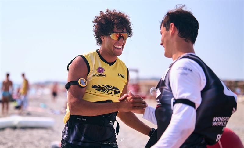 Alessandro Jose' Tomasi (ITA) is congratulated by Mathis Ghio (FRA) - 2026 Wingfoil Racing World Cup Calabria - photo © IWSA Media / Robert Hajduk