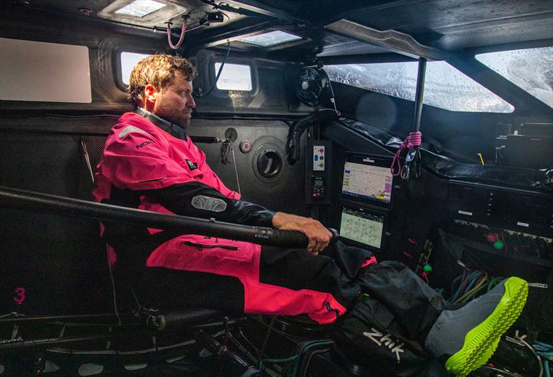 Alex Thomson helming from the cockpit - photo © Alex Thomson Racing